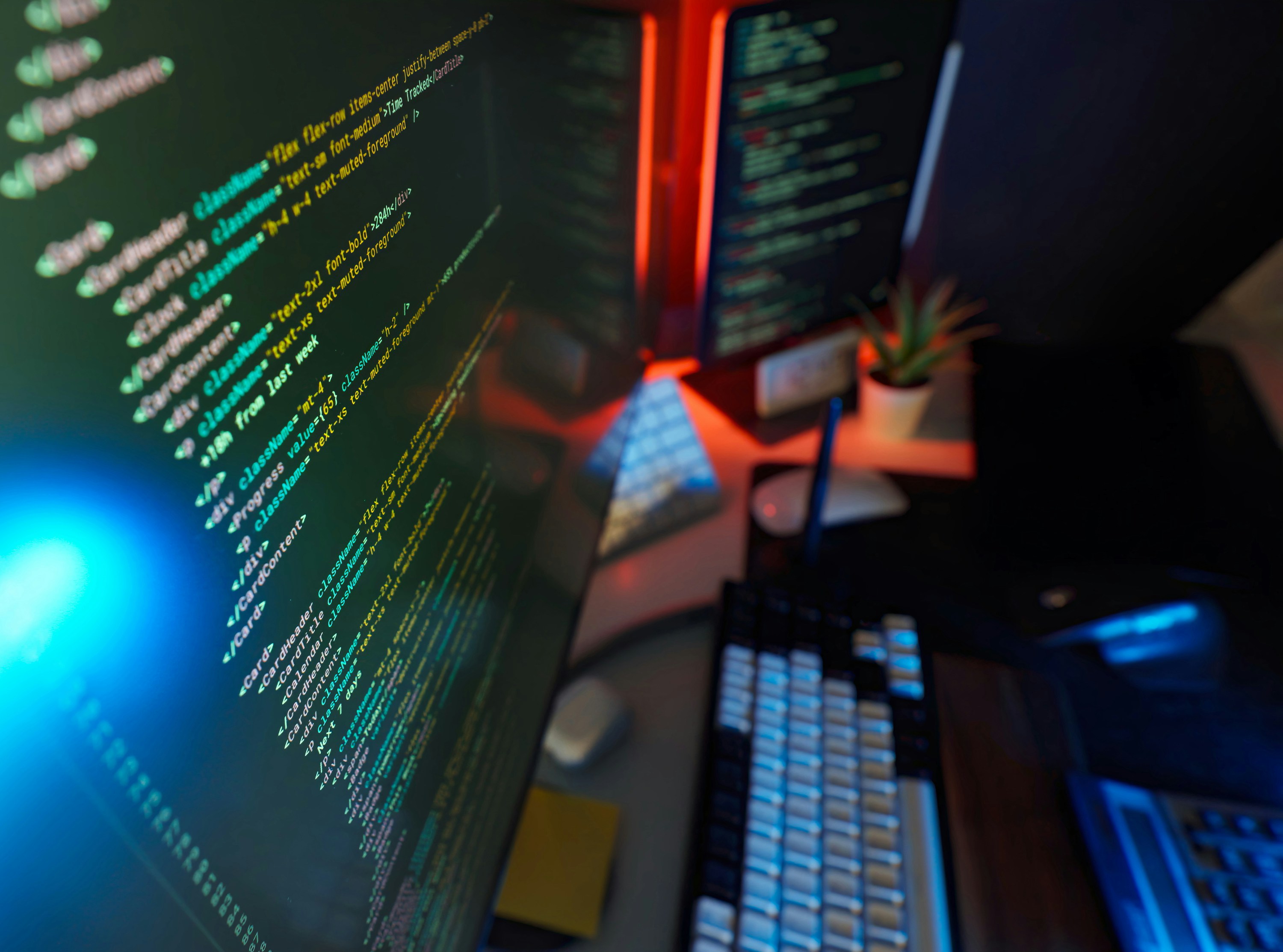 Developer workstation with code and website layouts on screen